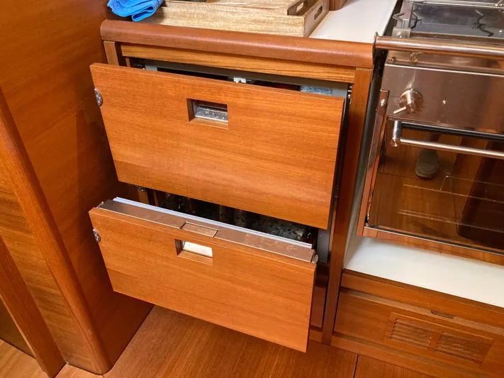  Yacht Photos Pics Wooden kitchen drawers in a 2022 Solaris 55 yacht interior.