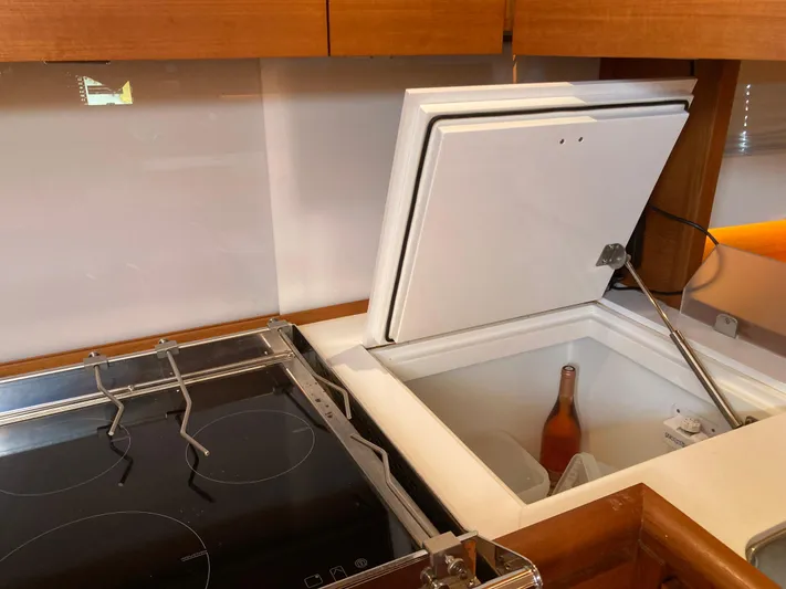  Yacht Photos Pics Modern kitchen on Solaris 55 yacht with open fridge and induction cooktop, 2022 model.