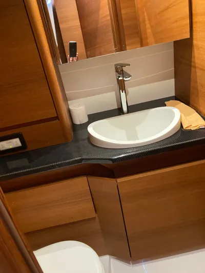  Yacht Photos Pics Luxurious bathroom interior of a 2022 Solaris 55 yacht with modern sink and wooden cabinetry.