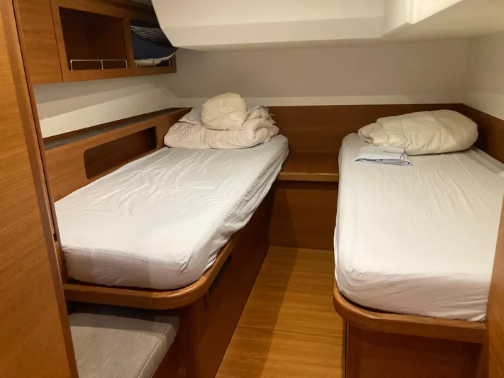  Yacht Photos Pics Cabin interior of 2022 Solaris 55 yacht with twin beds and wooden finish.