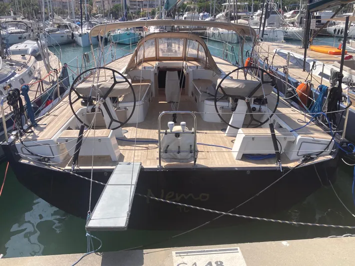  Yacht Photos Pics Luxury Solaris 55 yacht docked at marina, showcasing sleek design and dual steering wheels.