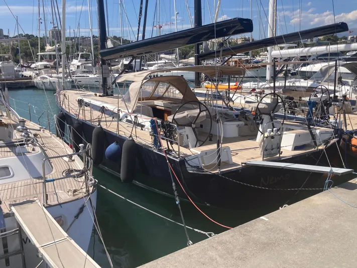  Yacht Photos Pics 2022 Solaris 55 yacht docked in a marina, surrounded by other boats.