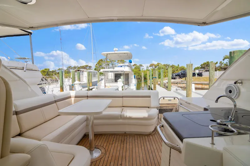  Yacht Photos Pics Luxurious 2013 Sea Ray 410 Sundancer yacht interior with seating and kitchenette, docked at marina.