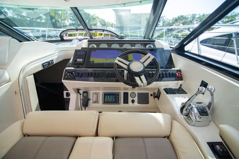  Yacht Photos Pics Cockpit of 2013 Sea Ray 410 Sundancer with modern navigation controls and steering wheel.