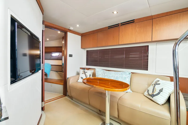  Yacht Photos Pics Luxurious interior of 2013 Sea Ray 410 Sundancer yacht with beige seating and wooden accents.