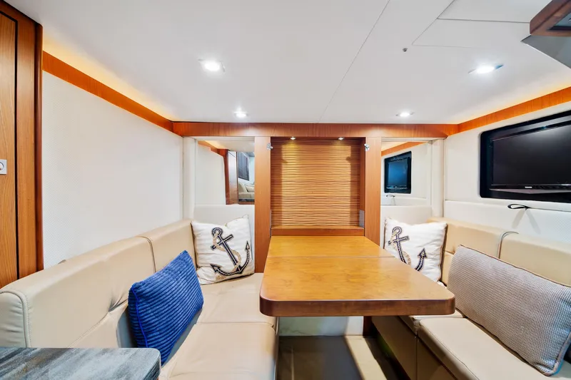 Yacht Photos Pics Luxurious interior of 2013 Sea Ray 410 Sundancer yacht with elegant seating and wooden table.