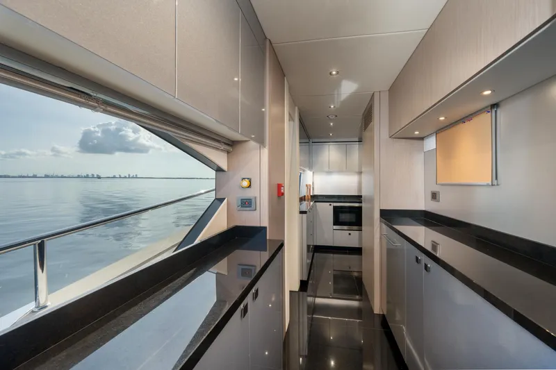 Eos Yacht Photos Pics Modern kitchen interior of 2021 Sunseeker 95 Yacht with ocean view.
