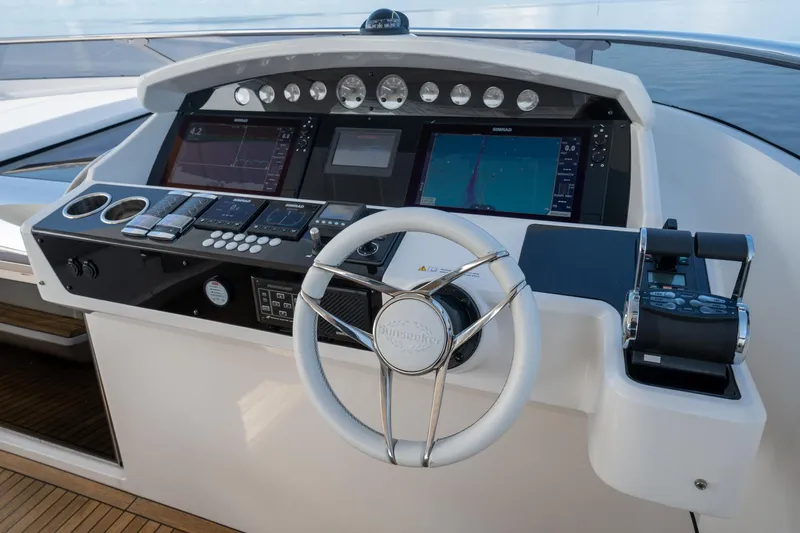 Eos Yacht Photos Pics Sunseeker 95 Yacht 2021 helm station with advanced navigation controls and steering wheel.