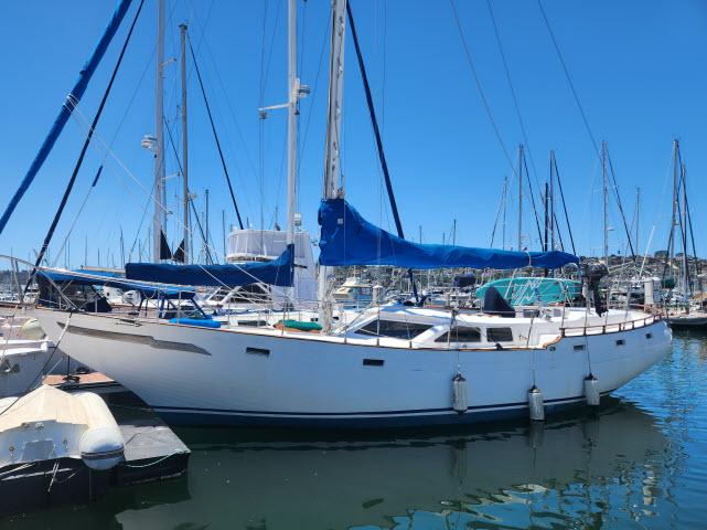 1978 Hardin Voyager 44 sailboat docked in a marina under clear blue skies.