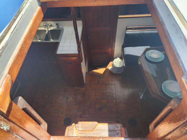 Interior view of 1978 Hardin Voyager 44 sailboat, featuring kitchen and dining area.
