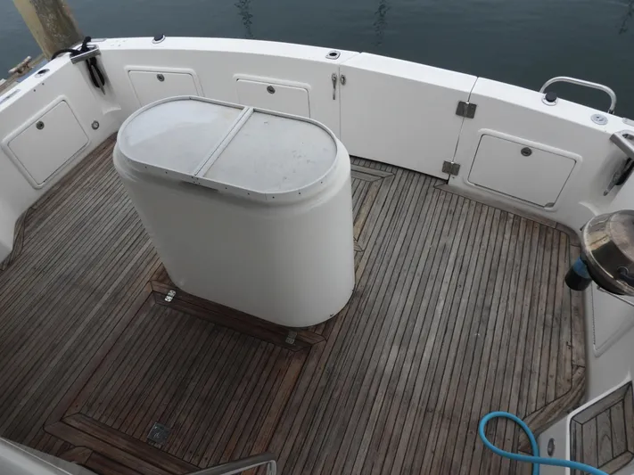  Yacht Photos Pics 1998 Riviera Convertible boat deck with wooden flooring and storage compartments.