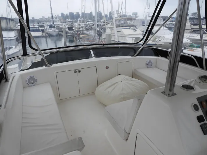  Yacht Photos Pics 1998 Riviera Convertible yacht interior with seating, docked at marina with city skyline view.