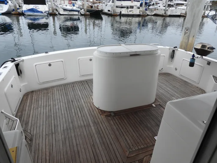  Yacht Photos Pics 1998 Riviera Convertible yacht deck with wooden flooring, docked at a marina.