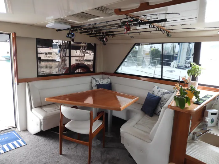  Yacht Photos Pics Interior of a 1998 Riviera Convertible yacht with seating, table, and fishing rods.
