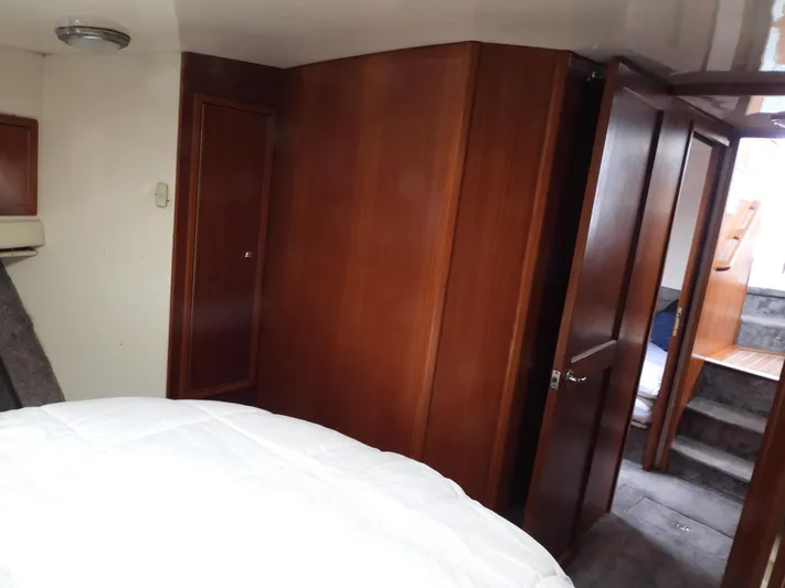  Yacht Photos Pics 1998 Riviera Convertible interior with wooden cabinetry and cozy sleeping area.