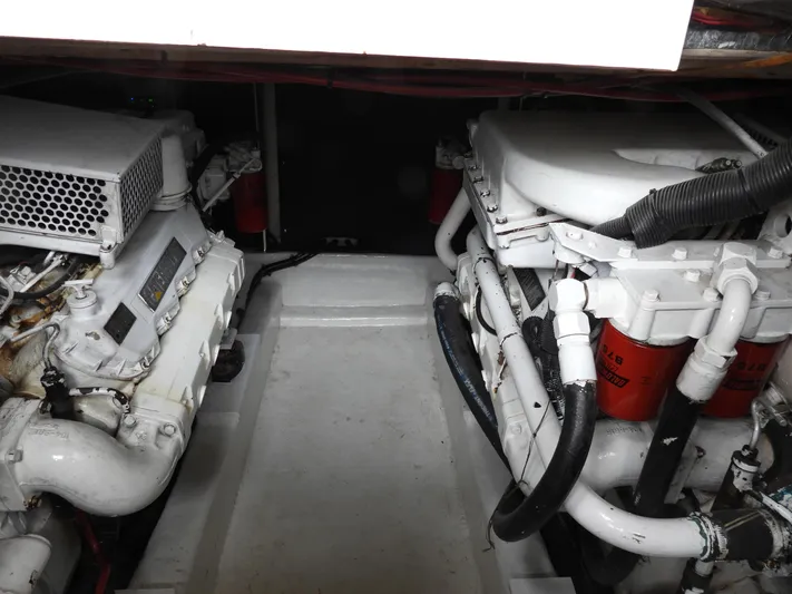  Yacht Photos Pics Engine room of a 1998 Riviera Convertible boat, showcasing dual engines and mechanical components.