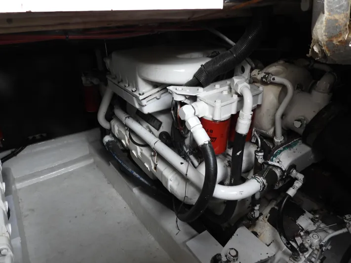  Yacht Photos Pics Engine compartment of a 1998 Riviera Convertible boat, showcasing mechanical components and hoses.