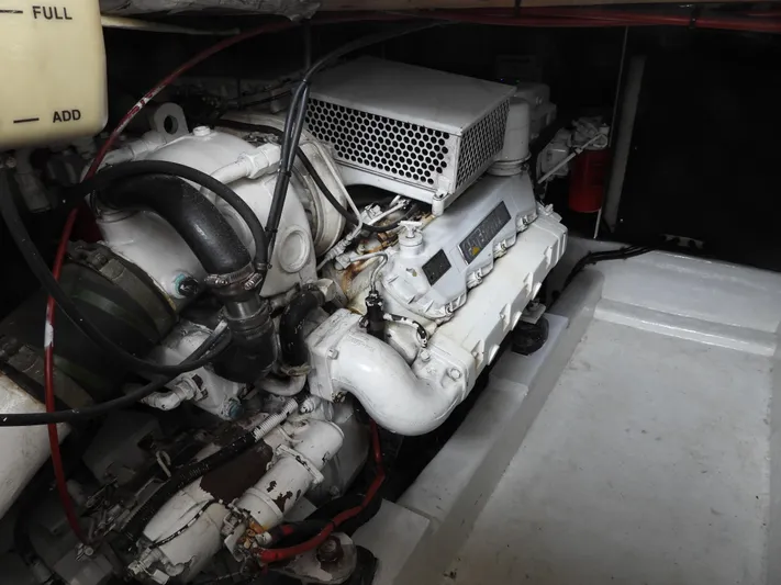  Yacht Photos Pics Engine compartment of a 1998 Riviera Convertible boat, showcasing mechanical components and wiring.