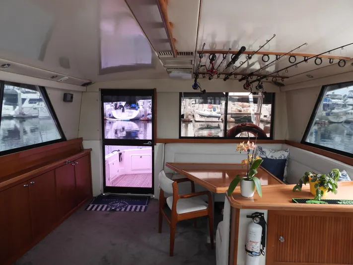  Yacht Photos Pics Interior of 1998 Riviera Convertible yacht with dining area and fishing rods.