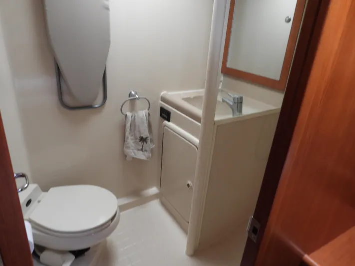  Yacht Photos Pics 1998 Riviera Convertible bathroom with toilet, sink, mirror, and towel rack.