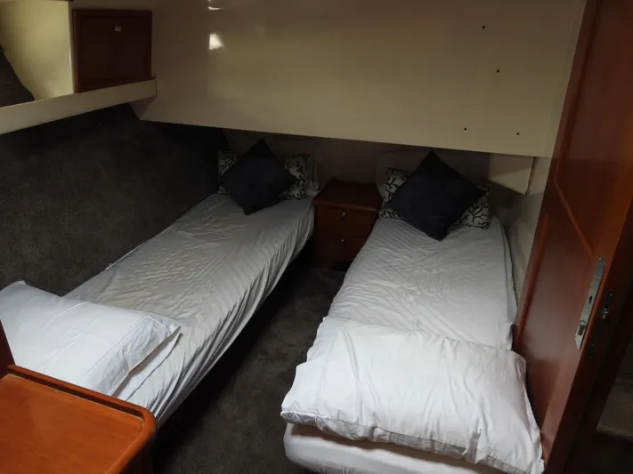  Yacht Photos Pics 1998 Riviera Convertible cabin with twin beds, white bedding, and wooden accents.