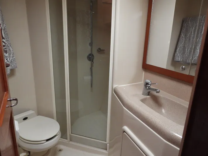  Yacht Photos Pics Compact bathroom in a 1998 Riviera Convertible, featuring a shower, toilet, and sink.