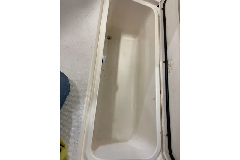  Yacht Photos Pics Storage compartment on a 2002 Riviera 34 Convertible boat, open and empty.