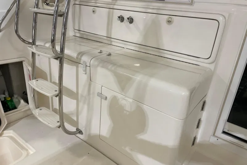 Yacht Photos Pics 2002 Riviera 34 Convertible yacht interior with ladder and storage compartments.