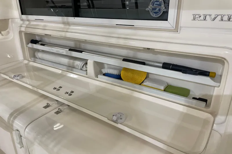  Yacht Photos Pics Storage compartment on 2002 Riviera 34 Convertible boat with cleaning tools and accessories.