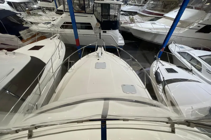  Yacht Photos Pics 2002 Riviera 34 Convertible yacht in a marina, surrounded by other boats.