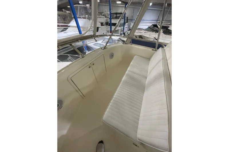  Yacht Photos Pics 2002 Riviera 34 Convertible boat interior with white seating and storage compartment.