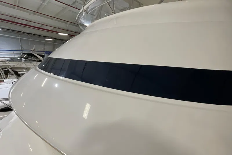  Yacht Photos Pics 2002 Riviera 34 Convertible yacht in indoor storage, showcasing sleek design and glossy finish.