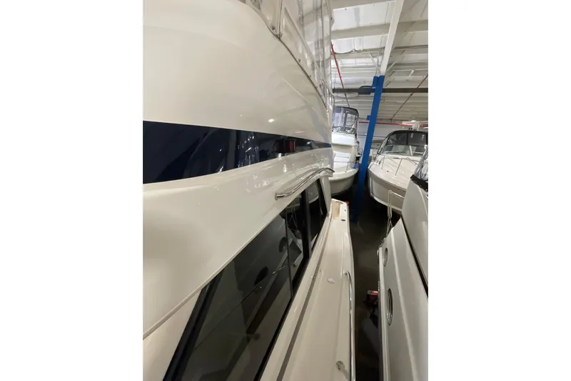  Yacht Photos Pics 2002 Riviera 34 Convertible yacht in indoor storage, side view.