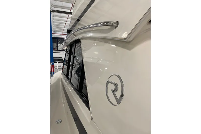  Yacht Photos Pics 2002 Riviera 34 Convertible yacht side view with logo and sleek design.