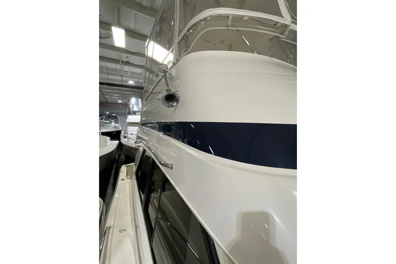  Yacht Photos Pics 2002 Riviera 34 Convertible yacht in indoor storage, showcasing sleek design and polished exterior.