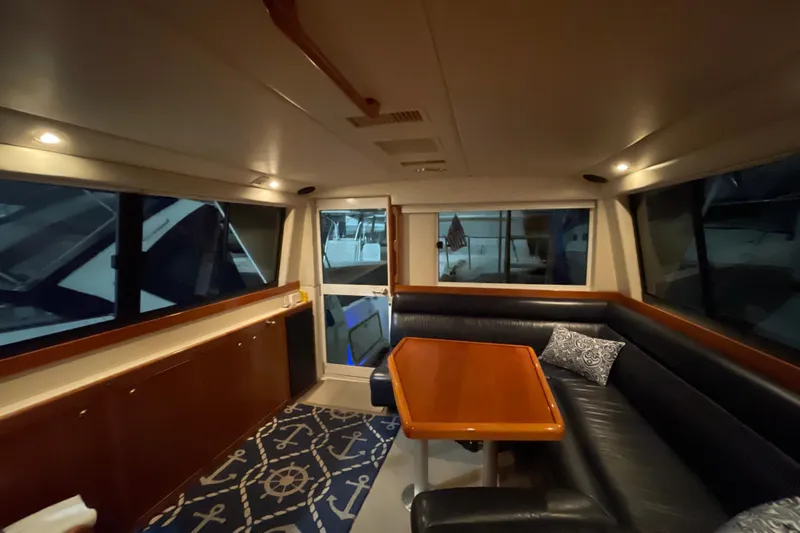  Yacht Photos Pics Interior of 2002 Riviera 34 Convertible yacht with cozy seating and nautical decor.