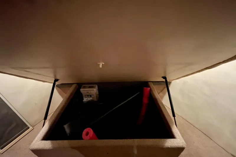  Yacht Photos Pics Storage compartment inside 2002 Riviera 34 Convertible boat, featuring hydraulic struts.