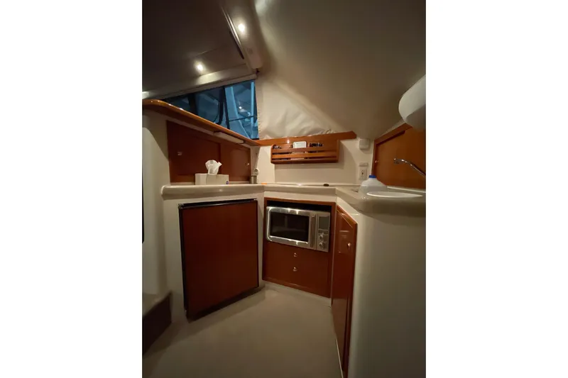  Yacht Photos Pics Interior of 2002 Riviera 34 Convertible yacht kitchen with modern appliances and wood cabinetry.