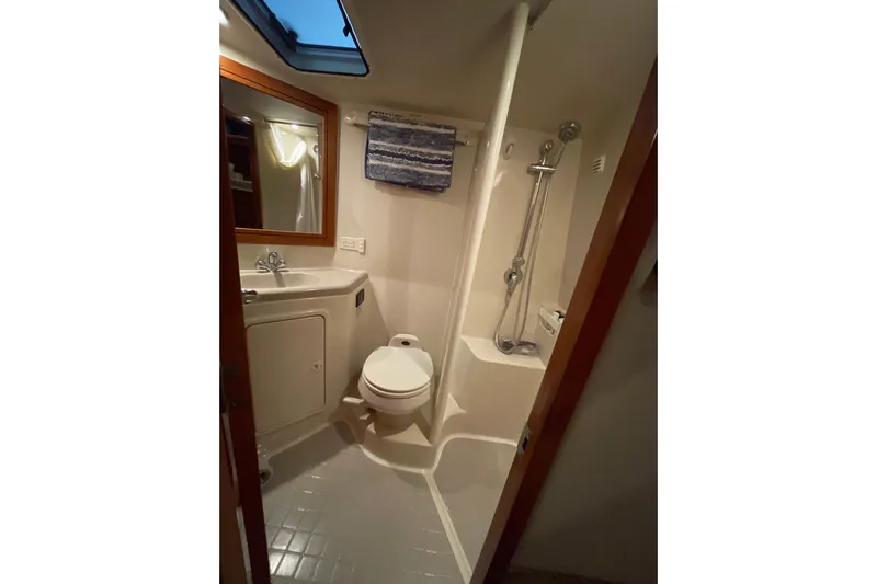  Yacht Photos Pics Bathroom interior of 2002 Riviera 34 Convertible yacht, featuring shower, sink, and toilet.