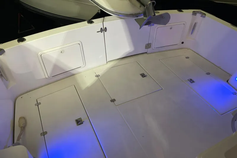  Yacht Photos Pics 2002 Riviera 34 Convertible boat deck with storage hatches and blue LED lighting.