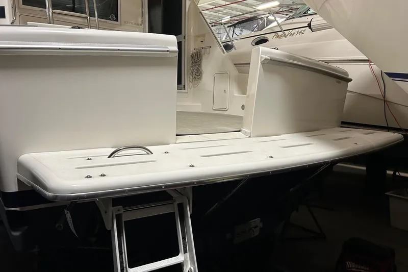  Yacht Photos Pics 2002 Riviera 34 Convertible yacht with swim platform and ladder in a marina.