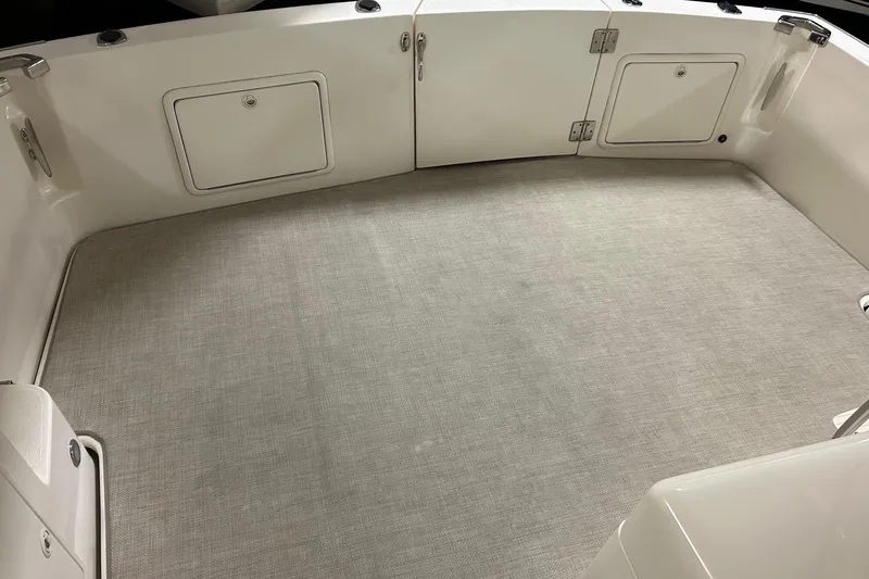  Yacht Photos Pics 2002 Riviera 34 Convertible boat deck with storage compartments and clean flooring.