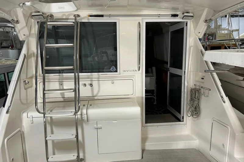  Yacht Photos Pics 2002 Riviera 34 Convertible yacht interior with ladder and open door.