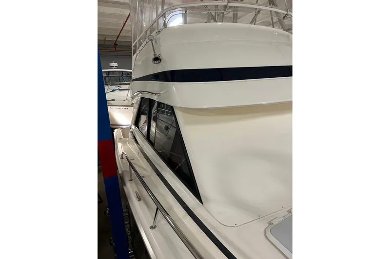  Yacht Photos Pics 2002 Riviera 34 Convertible yacht in a showroom, showcasing sleek design and structure.