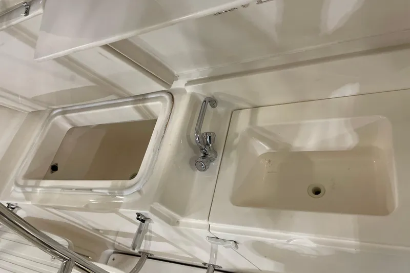  Yacht Photos Pics 2002 Riviera 34 Convertible boat interior with storage compartments and chrome handle.