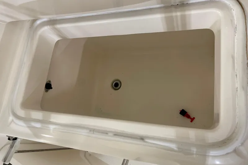  Yacht Photos Pics 2002 Riviera 34 Convertible boat interior compartment with drain plug.