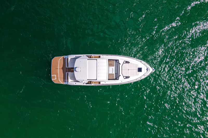  Yacht Photos Pics Aerial view of 2018 Cruisers Yachts 390 Express Coupe on vibrant green water.