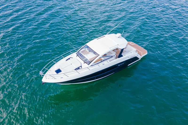  Yacht Photos Pics 2018 Cruisers Yachts 390 Express Coupe on open water, aerial view.