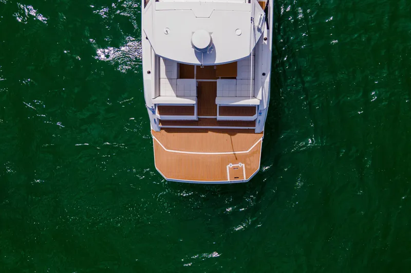  Yacht Photos Pics Aerial view of 2018 Cruisers Yachts 390 Express Coupe on green water.