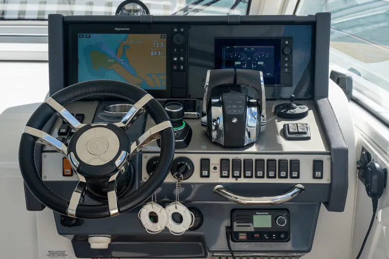  Yacht Photos Pics Control panel of 2018 Cruisers Yachts 390 Express Coupe with navigation screens and steering wheel.